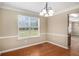 Dining room with natural light, chair rails, and hardwood flooring at 1000 Brushystone Dr, Loganville, GA 30052