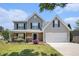 Charming two-story home with a well-manicured lawn and inviting front porch at 1000 Brushystone Dr, Loganville, GA 30052