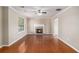 Spacious living room featuring a cozy fireplace and gleaming hardwood floors at 1000 Brushystone Dr, Loganville, GA 30052