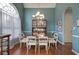Dining room with a large window, chandelier, hardwood floors, and classic décor at 192 Adelaide Xing, Acworth, GA 30101
