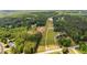 An aerial view showing property's location near wooded areas and available land at 220 Rocky Point Rd, Covington, GA 30014