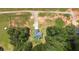 An aerial view of homesite nestled amongst the trees with drive and large yard at 220 Rocky Point Rd, Covington, GA 30014