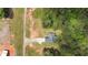 An aerial view showcasing the yard, driveway, and wooded surrounding the homesite at 220 Rocky Point Rd, Covington, GA 30014