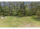A lovely backyard showing a grill, trampoline, and wooded trees beyond at 220 Rocky Point Rd, Covington, GA 30014