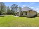 The exterior backyard of a home highlighting its large yard, patio and wooded area at 220 Rocky Point Rd, Covington, GA 30014