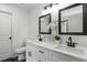 Modern bathroom with double sinks, dark fixtures, and a 'relax, refresh, and renew' sign at 220 Rocky Point Rd, Covington, GA 30014