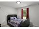 Cozy bedroom with a decorative bed frame, bright window, and neutral wall color at 220 Rocky Point Rd, Covington, GA 30014