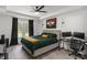 Spacious bedroom with tray ceiling, large windows, and dedicated desk workspace at 220 Rocky Point Rd, Covington, GA 30014