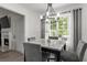 Charming dining area with views of a manicured lawn, modern chandelier and contemporary decor at 220 Rocky Point Rd, Covington, GA 30014