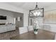 Bright dining room with a modern chandelier and a view into the living room at 220 Rocky Point Rd, Covington, GA 30014