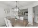 Elegant dining room with modern chandelier and views to the cozy living room at 220 Rocky Point Rd, Covington, GA 30014