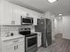 Well-equipped kitchen featuring stainless steel appliances, quartz countertops, and ample storage at 220 Rocky Point Rd, Covington, GA 30014