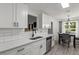 Stylish kitchen features white cabinets, modern appliances, and an adjacent dining area at 220 Rocky Point Rd, Covington, GA 30014