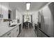 Modern kitchen features stainless steel appliances, sleek countertops, and an adjacent dining area at 220 Rocky Point Rd, Covington, GA 30014