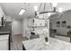 Bright kitchen featuring white cabinets, stainless steel appliances and a dining area at 220 Rocky Point Rd, Covington, GA 30014