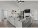 Bright living room with a vaulted ceiling, fireplace, large couch, and stylish ceiling fan at 220 Rocky Point Rd, Covington, GA 30014