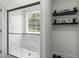 Stylish glass shower with marble-patterned walls, a window, and floating shelves on the wall at 220 Rocky Point Rd, Covington, GA 30014