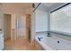 Bright bathroom featuring a soaking tub with jets, walk-in shower, and access to a walk-in closet at 2800 Araglin Dr, Dacula, GA 30019