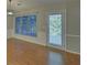 Bright living room featuring hardwood floors, large windows, and natural light at 2800 Araglin Dr, Dacula, GA 30019