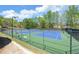 Well-maintained tennis courts surrounded by lush trees in a fenced-in community area at 2800 Araglin Dr, Dacula, GA 30019