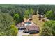 An aerial view of the house shows a large private lot surrounded by mature trees at 345 Etheridge Rd, Auburn, GA 30011