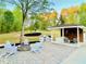 Outdoor living area with fire pit, built-in grill, and covered seating area at 345 Etheridge Rd, Auburn, GA 30011