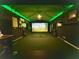 Entertainment room featuring a golf simulator and bar area with bright LED lighting at 345 Etheridge Rd, Auburn, GA 30011