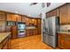 Gourmet kitchen features stainless steel appliances, granite countertops, hardwood floors, and dark wood cabinetry at 345 Etheridge Rd, Auburn, GA 30011