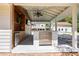 An outdoor kitchen is equipped with stainless steel appliances and overlooks a pool at 345 Etheridge Rd, Auburn, GA 30011