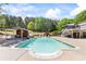 Backyard pool with outdoor kitchen and entertaining area, surrounded by mature trees at 345 Etheridge Rd, Auburn, GA 30011