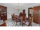 Traditional dining room with hardwood floors, large dining table, and decorative light fixture at 3521 Jefferson Township Pkwy, Marietta, GA 30066