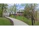 View of brick home with black shutters and an elongated driveway leading up to the house at 3521 Jefferson Township Pkwy, Marietta, GA 30066
