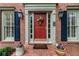 Close up view of brick home's front door with potted plants and sidelights at 3521 Jefferson Township Pkwy, Marietta, GA 30066