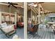 Large screened porch with multiple seating areas, perfect for relaxing and enjoying the wooded views at 3521 Jefferson Township Pkwy, Marietta, GA 30066