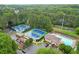 Resort-style community featuring tennis courts, pool, and playground amidst a lush, wooded landscape at 4213 Schooner Ne Ct, Roswell, GA 30075