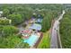 Community area featuring a large swimming pool, tennis courts and playground, all nestled in a wooded setting at 4213 Schooner Ne Ct, Roswell, GA 30075