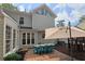 Backyard featuring brick patio, dining set, and play area with a modern siding at 4213 Schooner Ne Ct, Roswell, GA 30075