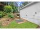 Backyard featuring a stone pathway and retaining wall with a grassy area at 4213 Schooner Ne Ct, Roswell, GA 30075