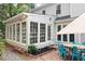Backyard featuring a brick patio and sunroom with multiple windows and a dining set at 4213 Schooner Ne Ct, Roswell, GA 30075