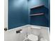Half bath with a toilet, floating wood shelves, and modern fixtures at 4213 Schooner Ne Ct, Roswell, GA 30075