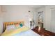 Sunny bedroom featuring hardwood floors, a bed with colorful linens, and ample storage at 4213 Schooner Ne Ct, Roswell, GA 30075