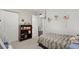 Cozy bedroom with a bookcase, bed, and open door to the bathroom at 4213 Schooner Ne Ct, Roswell, GA 30075