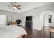 Large bedroom with dark wood floors, a ceiling fan, and ensuite bath at 4213 Schooner Ne Ct, Roswell, GA 30075