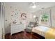 Vibrant bedroom with colorful unicorn wall art, a cozy bed, and natural light at 4213 Schooner Ne Ct, Roswell, GA 30075