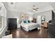 Spacious bedroom features a tray ceiling, hardwood floors, and an ensuite bath at 4213 Schooner Ne Ct, Roswell, GA 30075