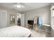 Bright bedroom featuring a ceiling fan, neutral paint, and an adjacent laundry room at 4213 Schooner Ne Ct, Roswell, GA 30075