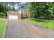 Two-story brick home with attached garage, manicured lawn, and mature trees at 4213 Schooner Ne Ct, Roswell, GA 30075