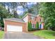 Charming two-story brick home featuring an attached garage and well-manicured lawn at 4213 Schooner Ne Ct, Roswell, GA 30075