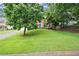Charming two-story home with a beautifully landscaped front yard and a blue front door at 4213 Schooner Ne Ct, Roswell, GA 30075