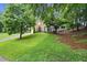 Charming two-story home with a well-manicured lawn and a blue front door at 4213 Schooner Ne Ct, Roswell, GA 30075
